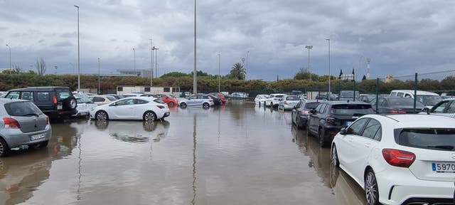 <p>Vehicles parked in a flooded car park after heavy rains, at Palma de Mallorca airport, in Palma de Mallorca</p>