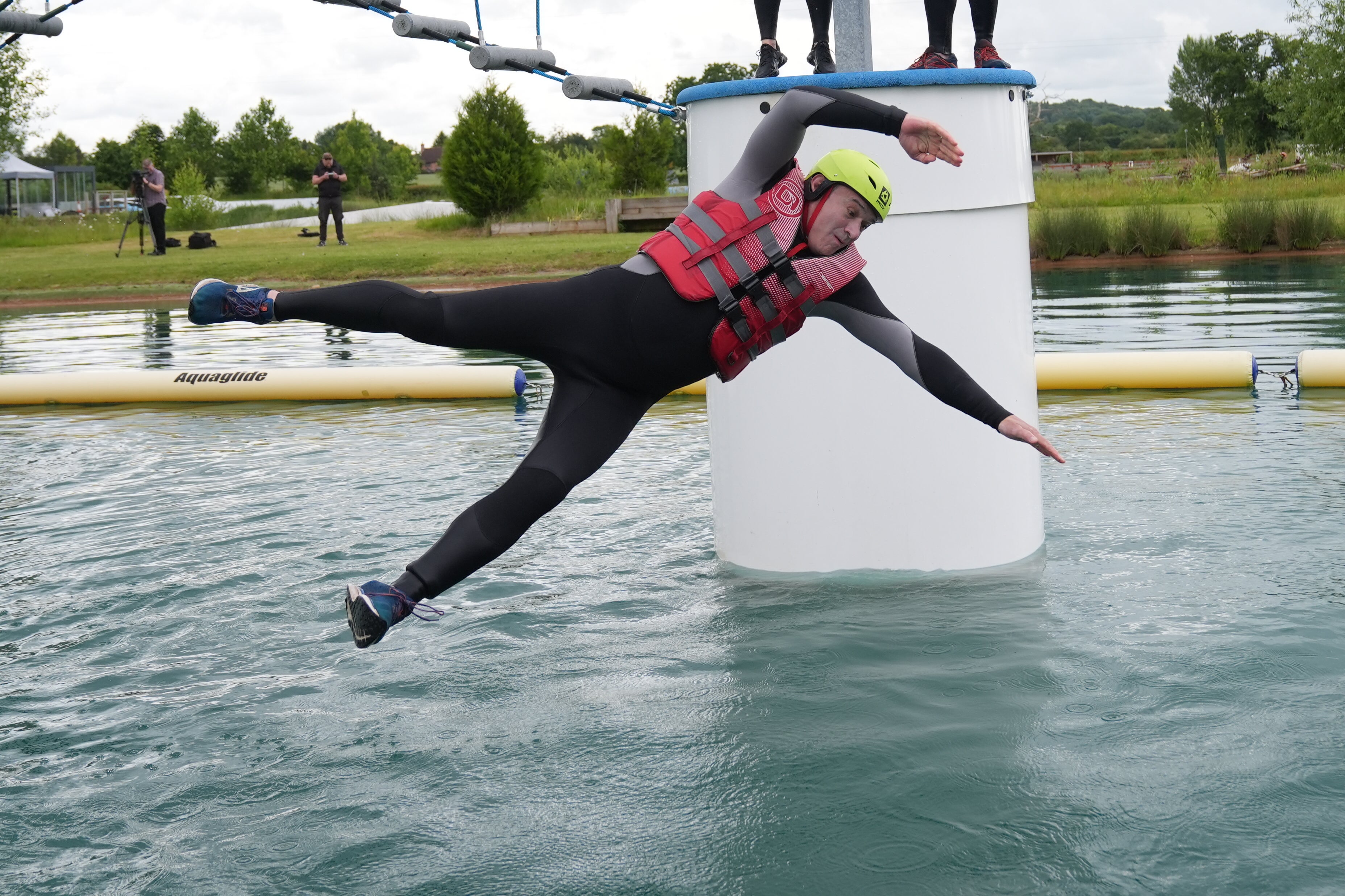 Liberal Democrats leader Sir Ed Davey falls as he attempts an Aqua Jungle floating assault course during a visit to Spot-On-Wake in Henley-in-Arden, Warwickshire