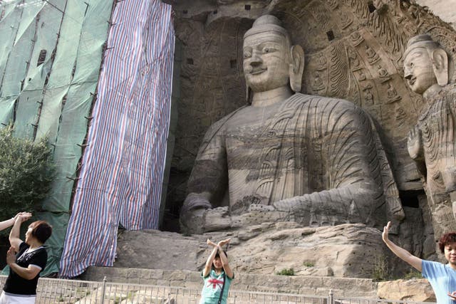<p>File Visitors view Buddhist sculptures at the Yungang Grottoes on 6 August 2006 in Datong of Shanxi Province, China</p>