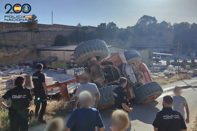 <p>Police investigate the overturned excavator </p>