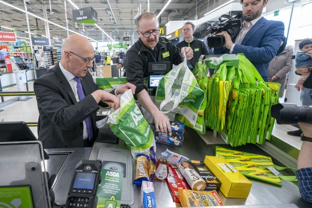 John Swinney spent a brief stint behind the tills at Asda (Jane Barlow/PA)