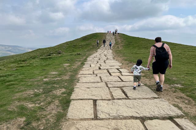 <p>Hikers make their way up Mam Tor, a 517 meters high (1,696 feet) hill in England’s Peak District </p>