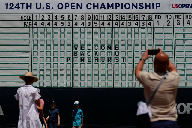 Fans gather around the main scoreboard during a practice round for the 124th US Open at Pinehurst (Matt York/AP)