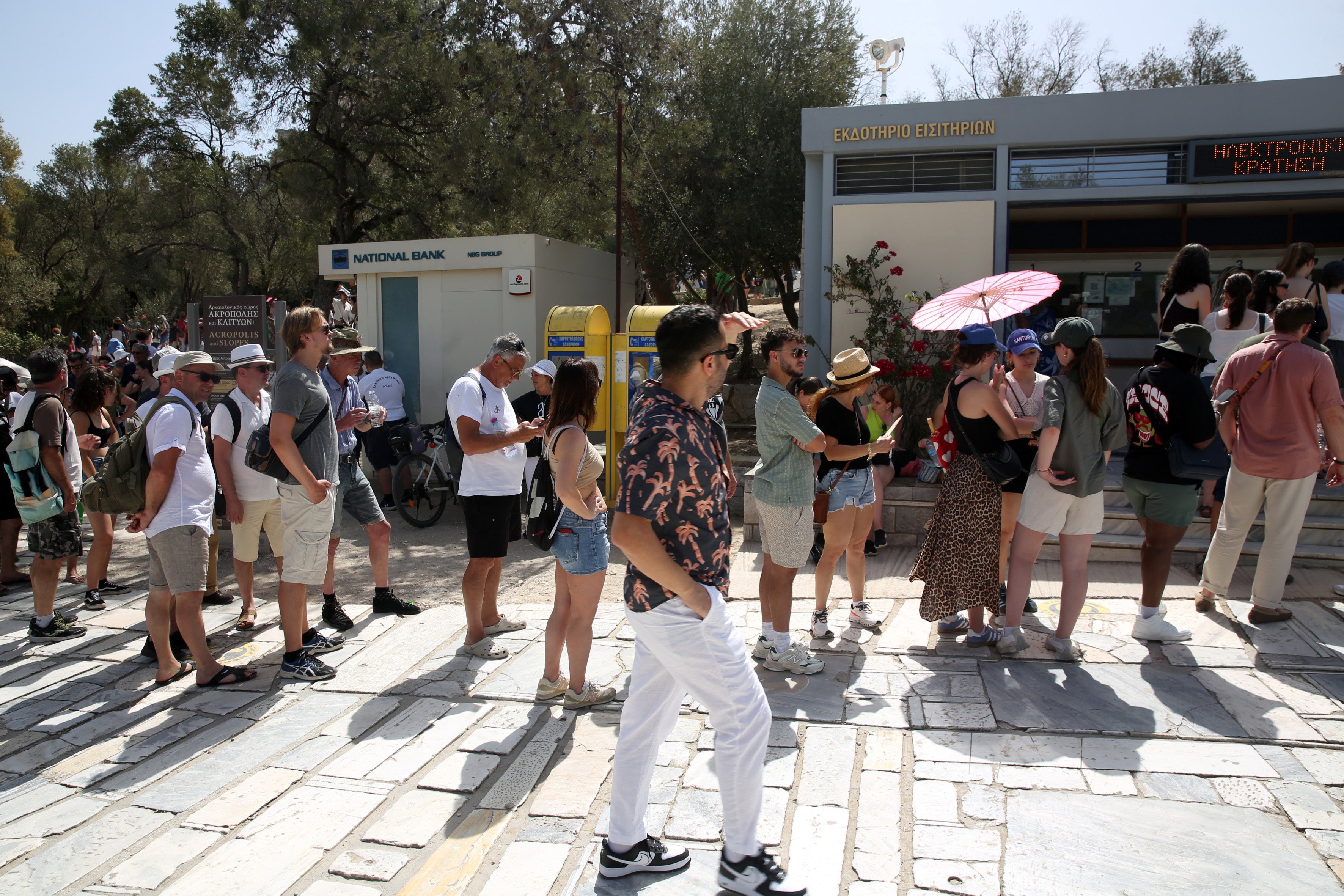 Tourists wait in line to get a ticket at the entrance to the archaeological site of the Acropolis, Athens, Greece, 12 June 2024