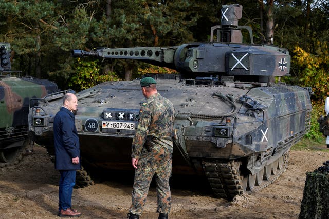 <p>German Chancellor Olaf Scholz stands in front of a Puma vehicle during a visit to a military base of the German army Bundeswehr in Bergen, Germany, October 17, 2022</p>