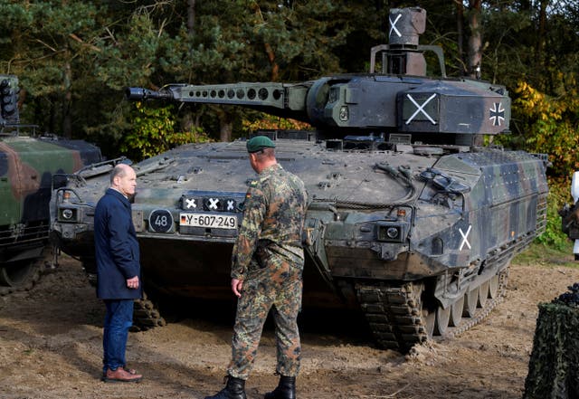 <p>German Chancellor Olaf Scholz stands in front of a Puma vehicle during a visit to a military base of the German army Bundeswehr in Bergen, Germany, October 17, 2022</p>