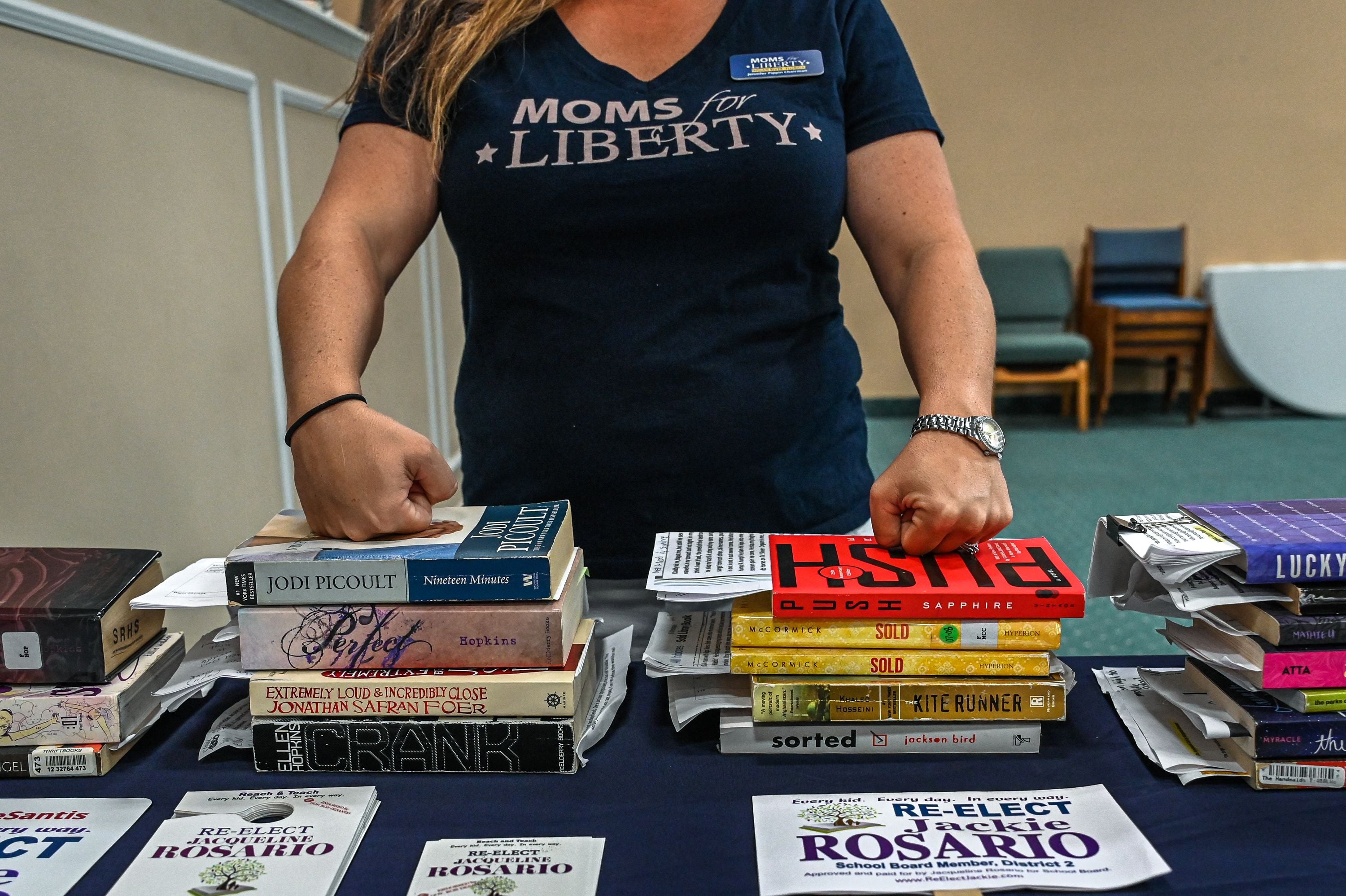 Jennifer Pippin, president of the local Moms for Liberty chapter, pictured with several books. She advocated to ban “Ban This Book” by Alan Gratz in the Indian River County School District