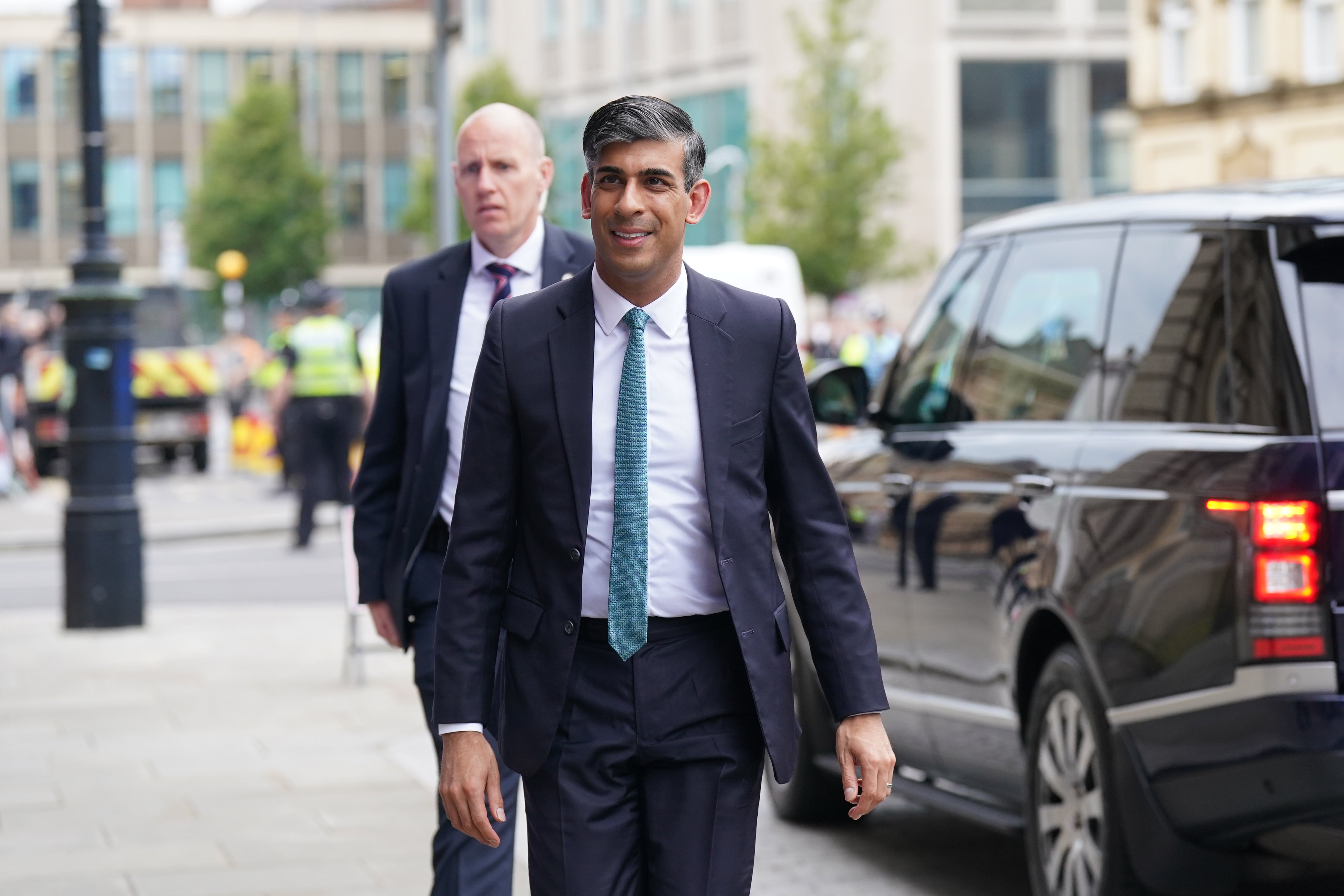 Prime Minister Rishi Sunak (C) arrives for a Sky News election event on June 12, 2024 in Grimsby
