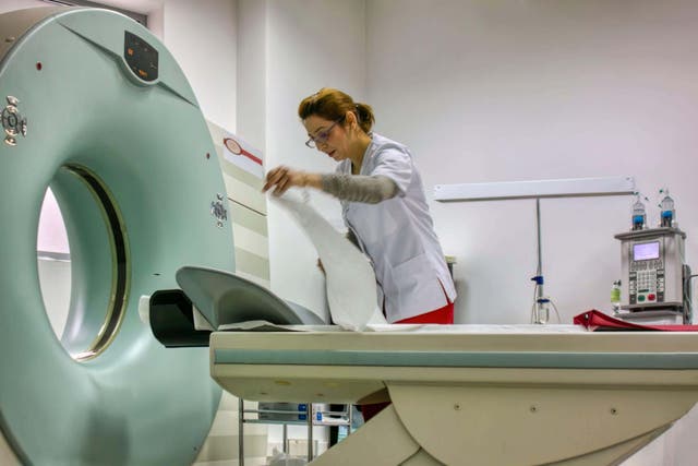 A nurse arranging the MRI machine (Alamy/PA)