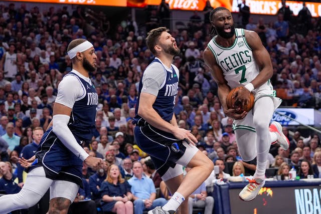 Boston Celtics guard Jaylen Brown, right, reacts while attempting a shot (Tony Gutierrez/AP)