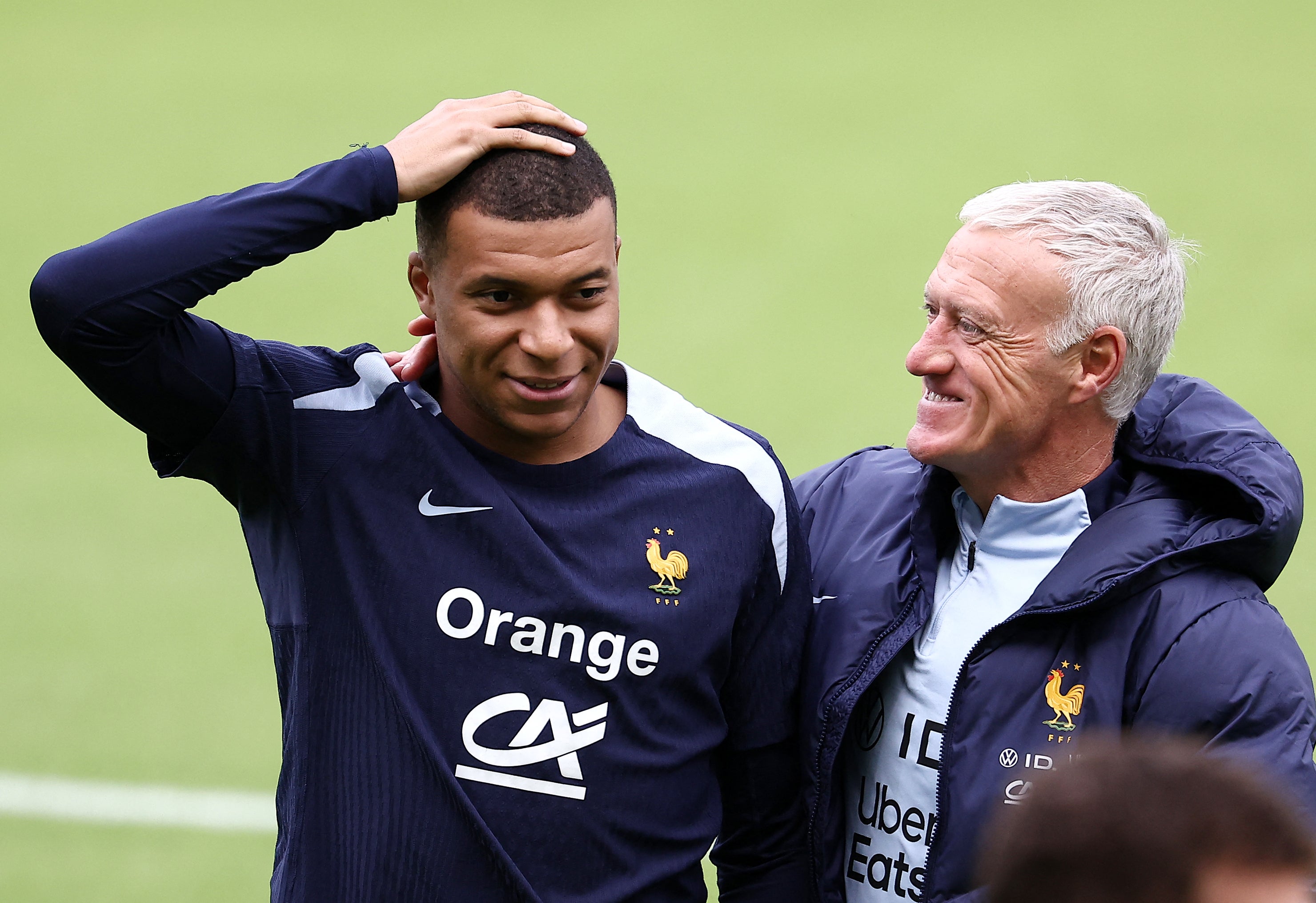 France’s forward Kylian Mbappe speaks with France’s head coach Didier Deschamps