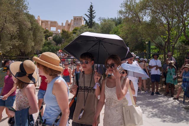 <p>Tourists exit the ancient Acropolis in central Athens</p>