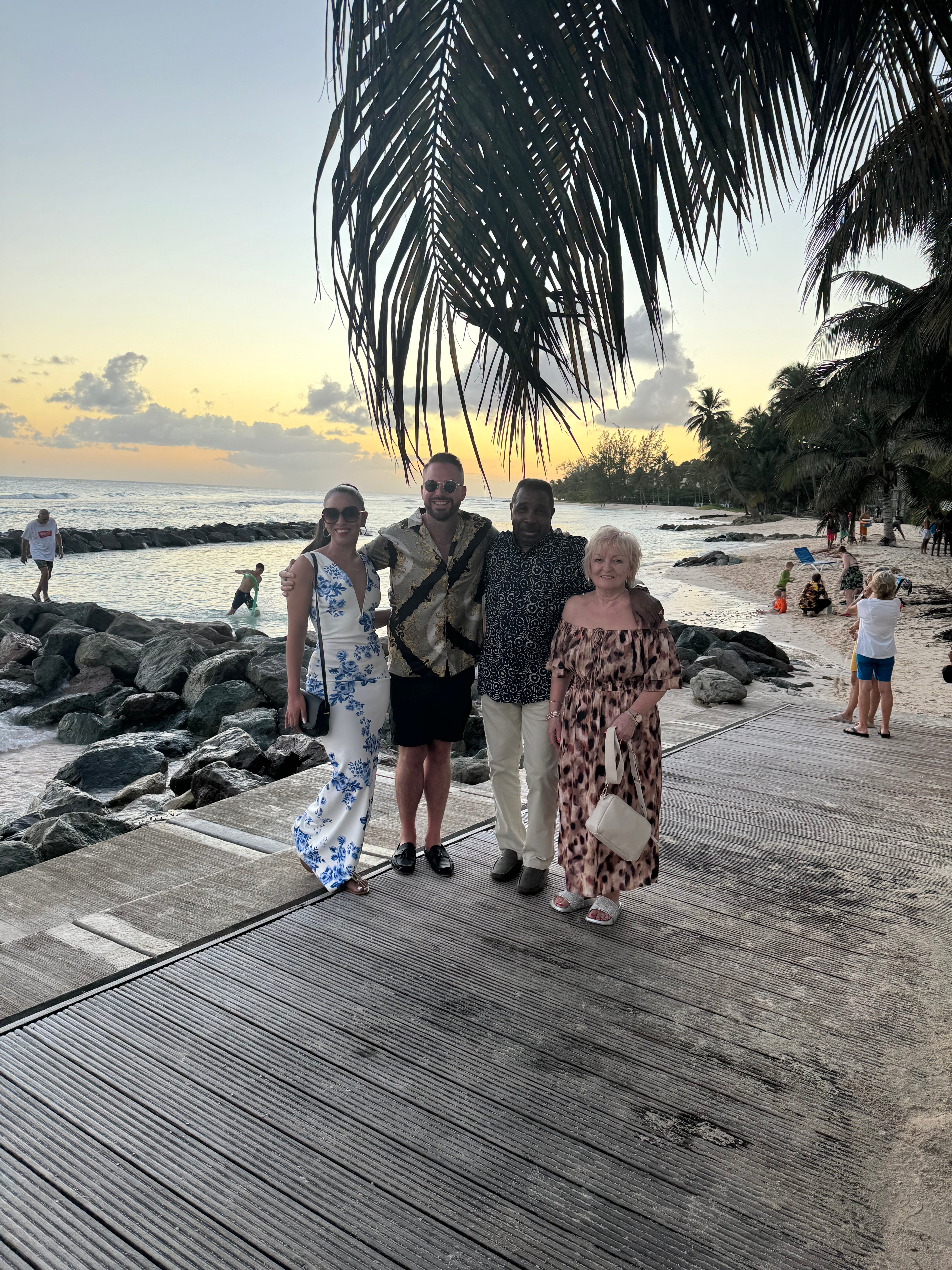 Adam and Victoria Blakey with Victoria's parents on the night of proposal on Christchurch beach in Barbados (Collect/PA Real Life)