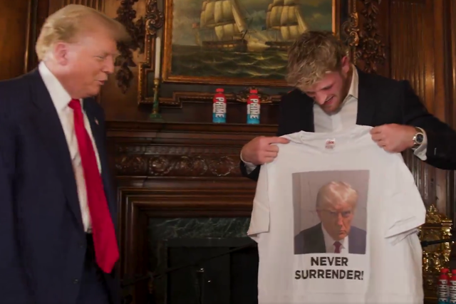 <p>Donald Trump presents Logan Paul with a T-shirt bearing his mugshot ahead of their podcast interview on June 13 2024</p>