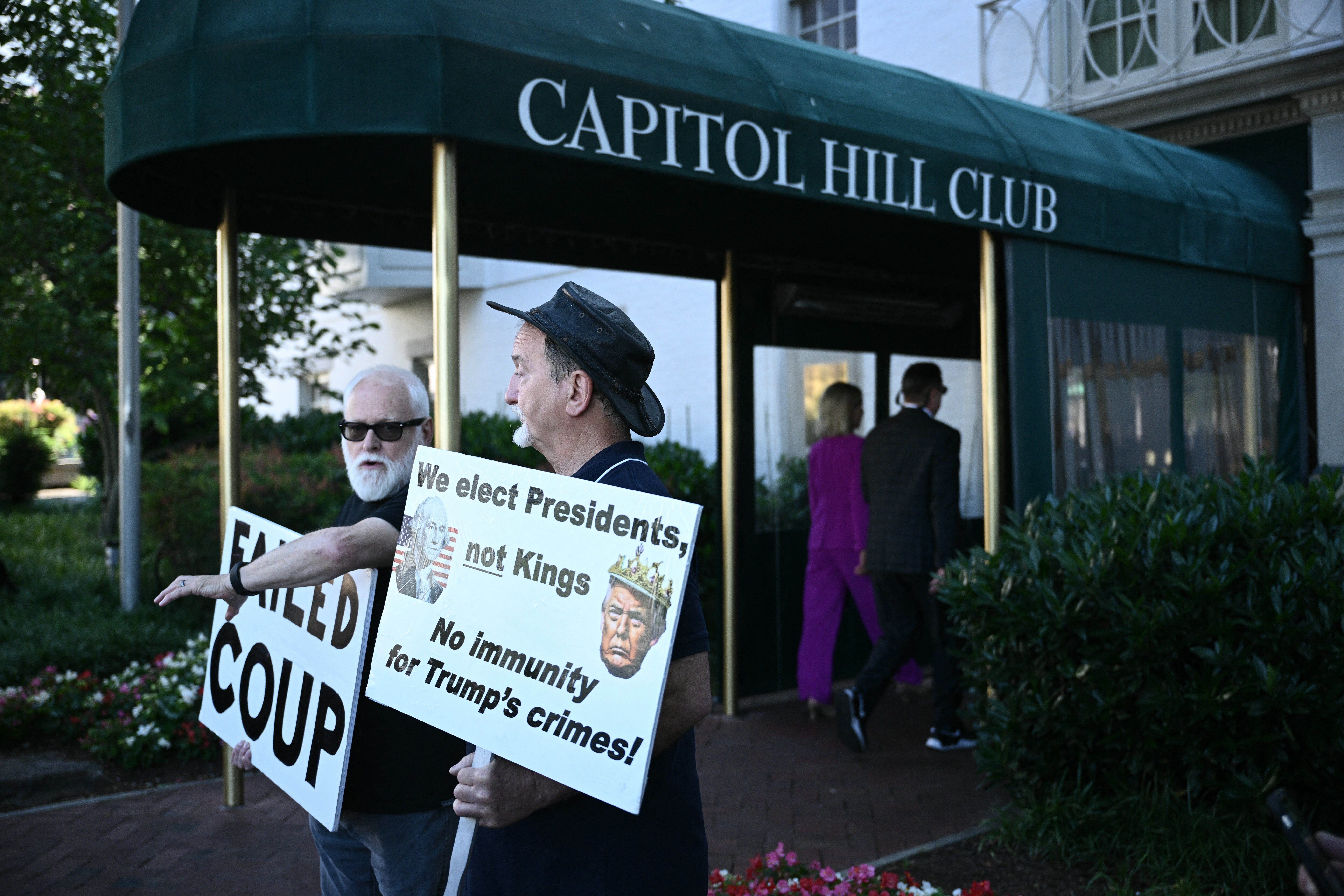 Protesters outside the Capitol Hill Club where Donald Trump will meet with Republican lawmakers to discuss his plans for a potential second term in the White House