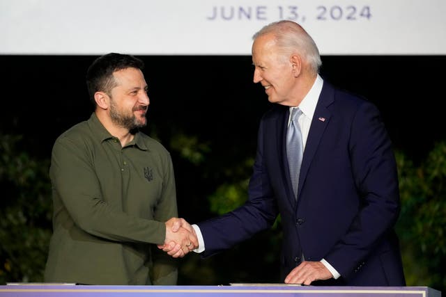 <p>U.S. President Joe Biden, right, shakes hands with Ukraine's President Volodymyr Zelenskyy as they sign a bilateral security agreement during the sidelines of the G7 summit at Savelletri, Italy, Thursday, June 13, 2024. </p>