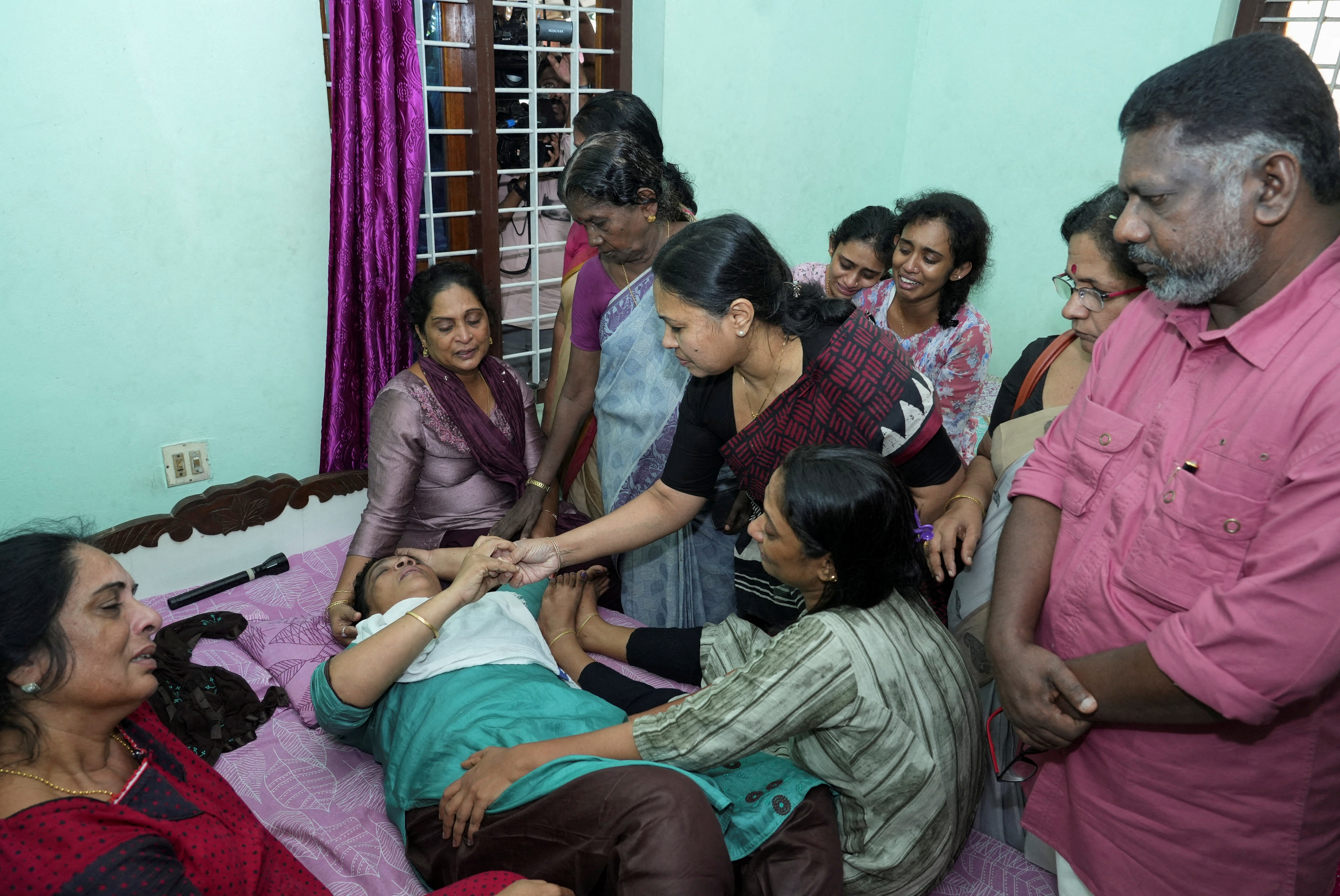 Kerala’s health minister Veena George consoles the mother of Akash Sasidharan Nair, one of the victims of the Kuwait fire