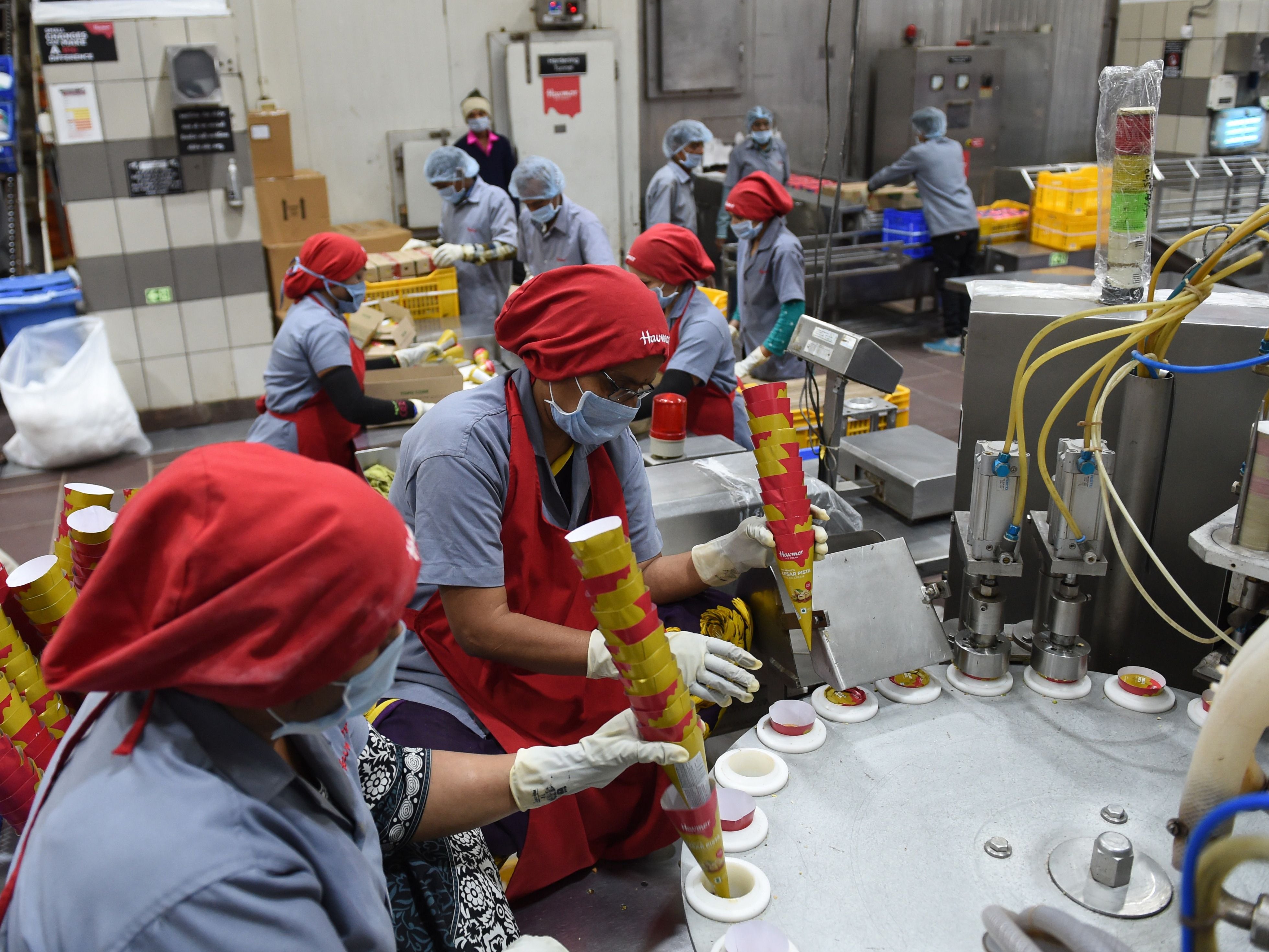 <p>For representational purposes only. Indian factory workers prepare ice cream cones on an assembly line at an ice cream plant in Naroda, near Ahmedabad, Gujarat</p>