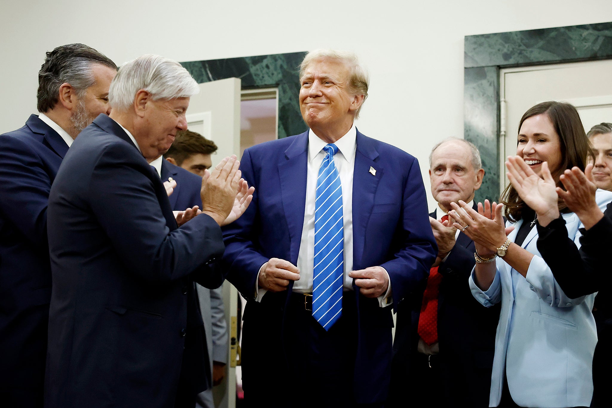 Trump is applauded by Senate Republicans in Washington DC on Thursday