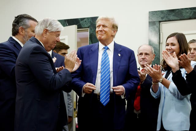 <p>Republican presidential candidate Donald Trump is applauded by Senate Republicans in Washington DC on Thursday June 13 2024 </p>