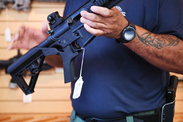 <p>A gun salesman demonstrates a bump stock on an AR-style rifle in Virgina. On June 14, the US Supreme Court reversed a federal ban on the devices.</p>