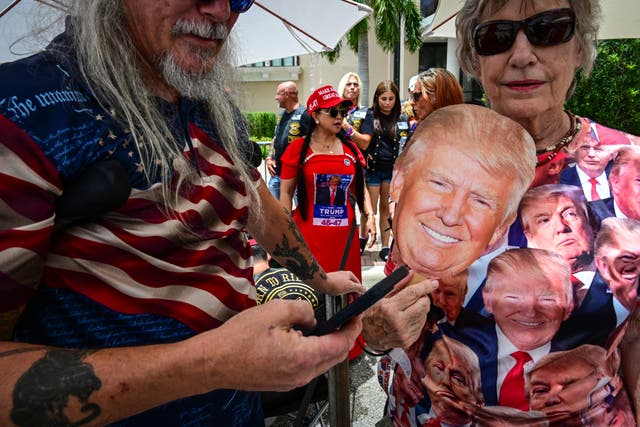 <p>Supporters of former US President Donald Trump wait to enter his birthday campaign rally at the West Palm Convention Center in Florida</p>