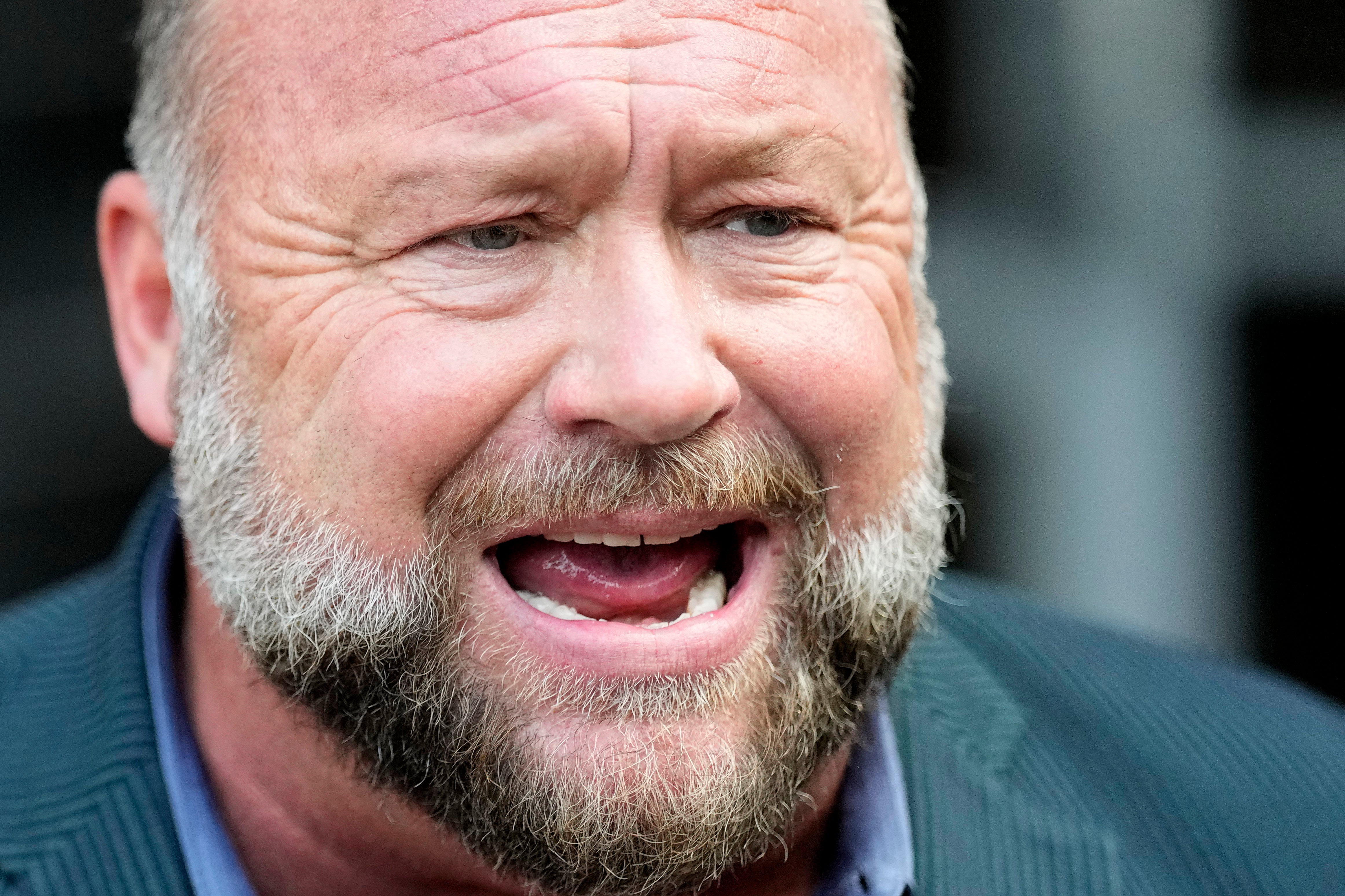 Right-wing conspiracy theorist Alex Jones speaks to the media after arriving at the federal courthouse for a hearing in front of a bankruptcy judge Friday, June 14, 2024