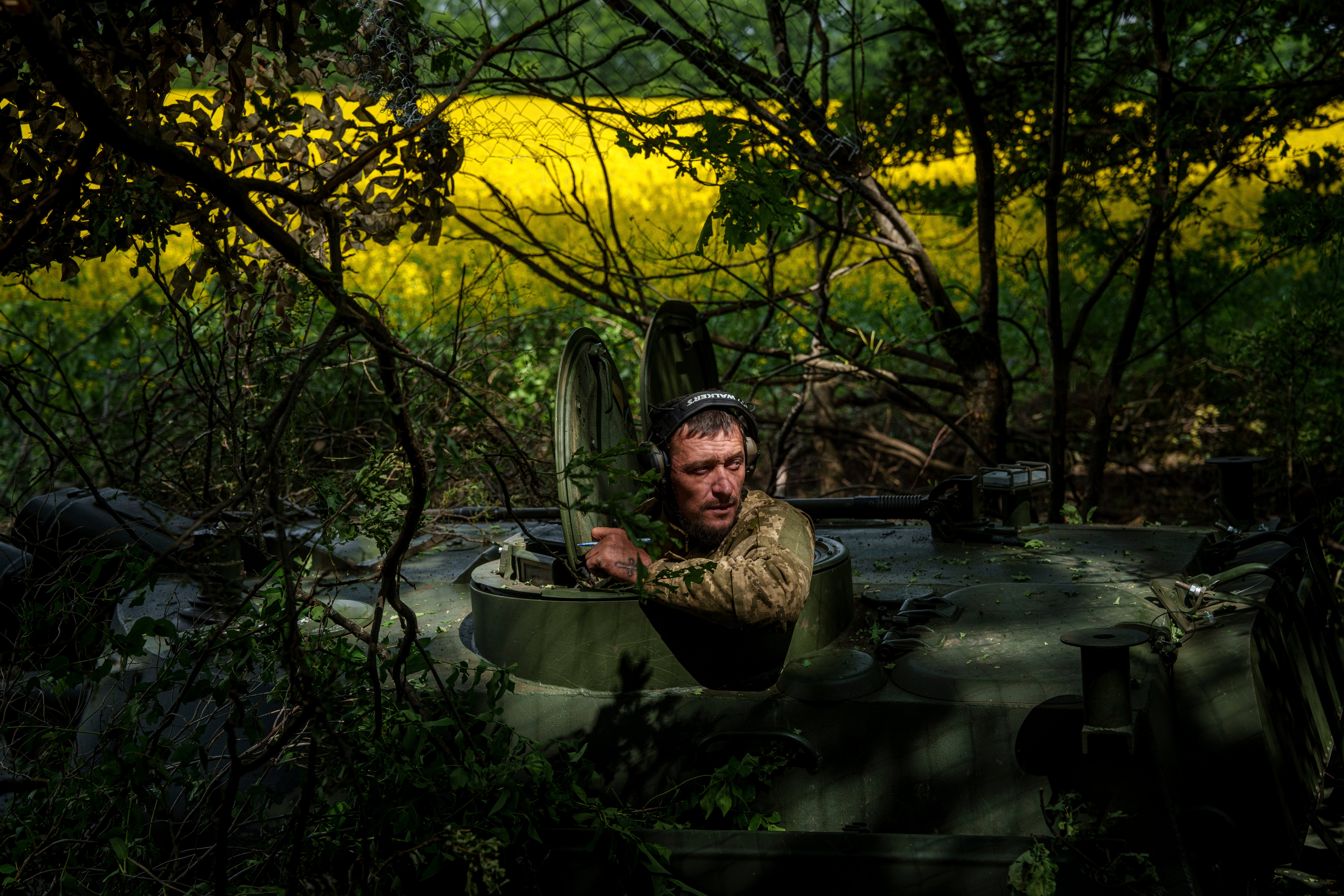 A Ukrainian soldier from the 57th Brigade waits for an order for his artillery vehicle to open fire on Russian positions at the front line in Ukraine’s Kharkiv region