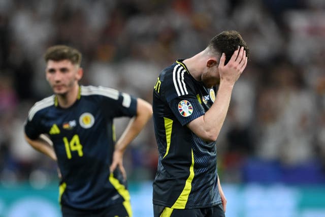 <p>Andy Robertson of Scotland looks dejected after defeat to Germany</p>