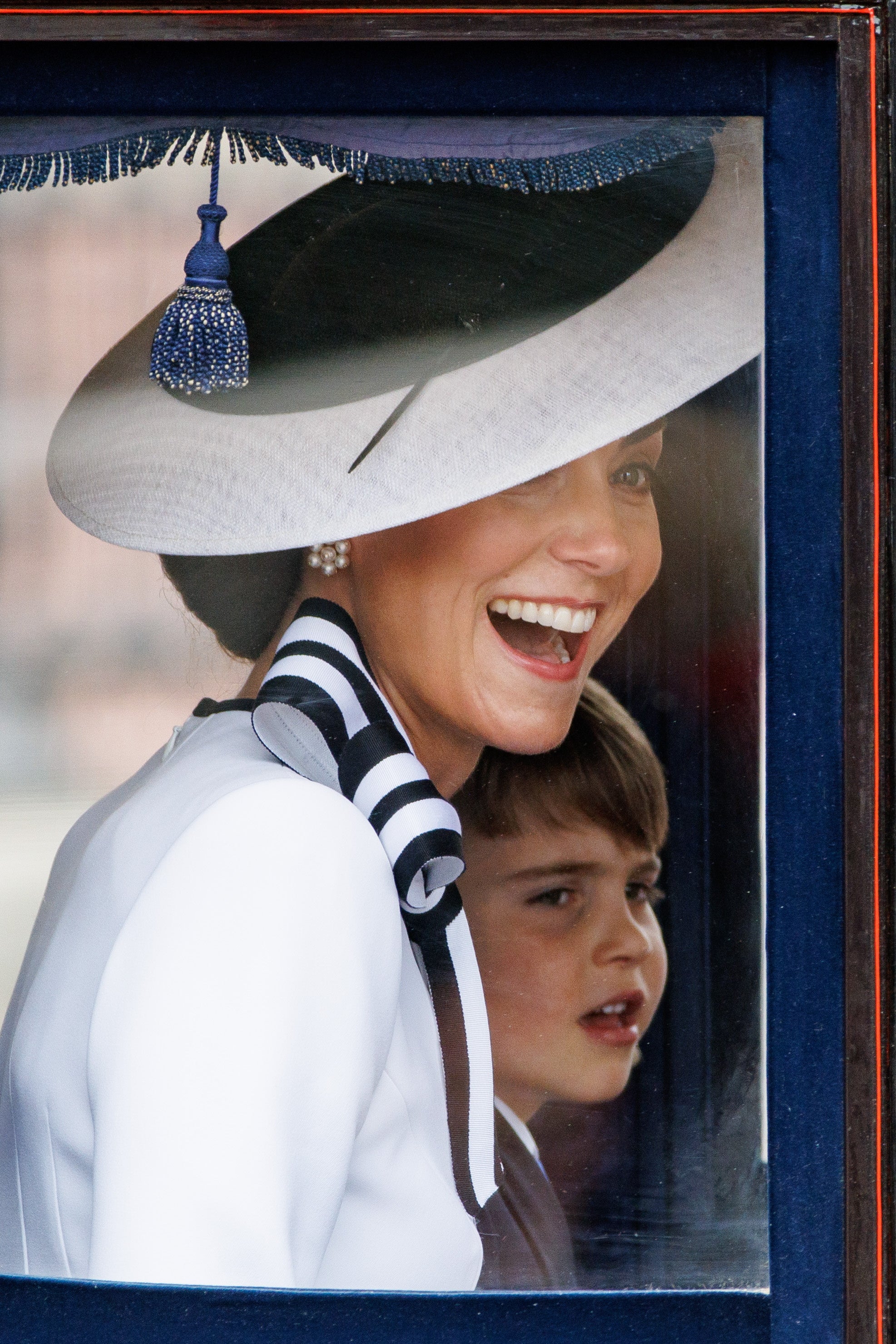 Kate was beaming from the carriage as she watched the parade with her youngest, Louis