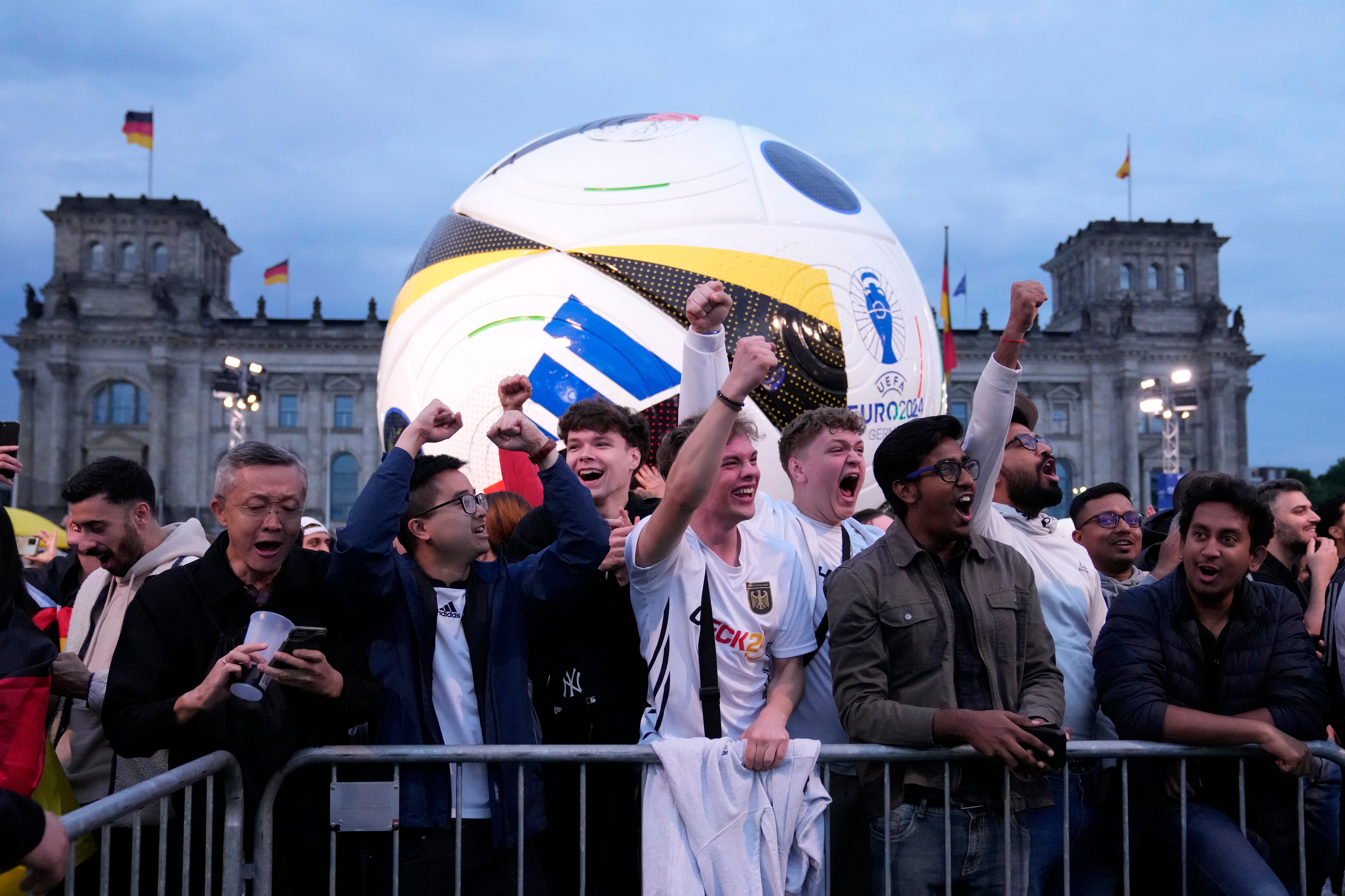 Fans cheer while watching coverage in Berlin