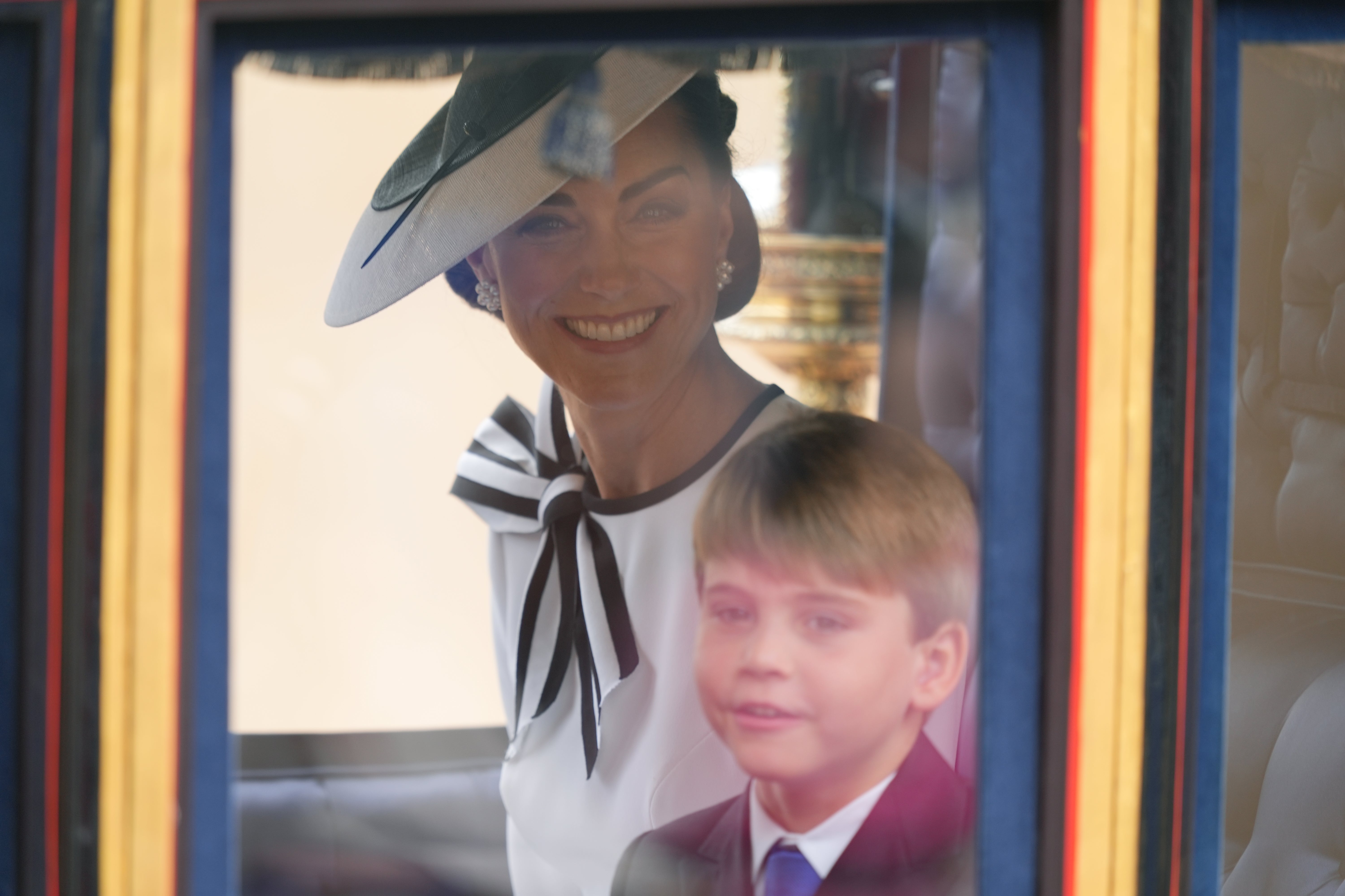 The princess was seen smiling in her carriage alongside son George