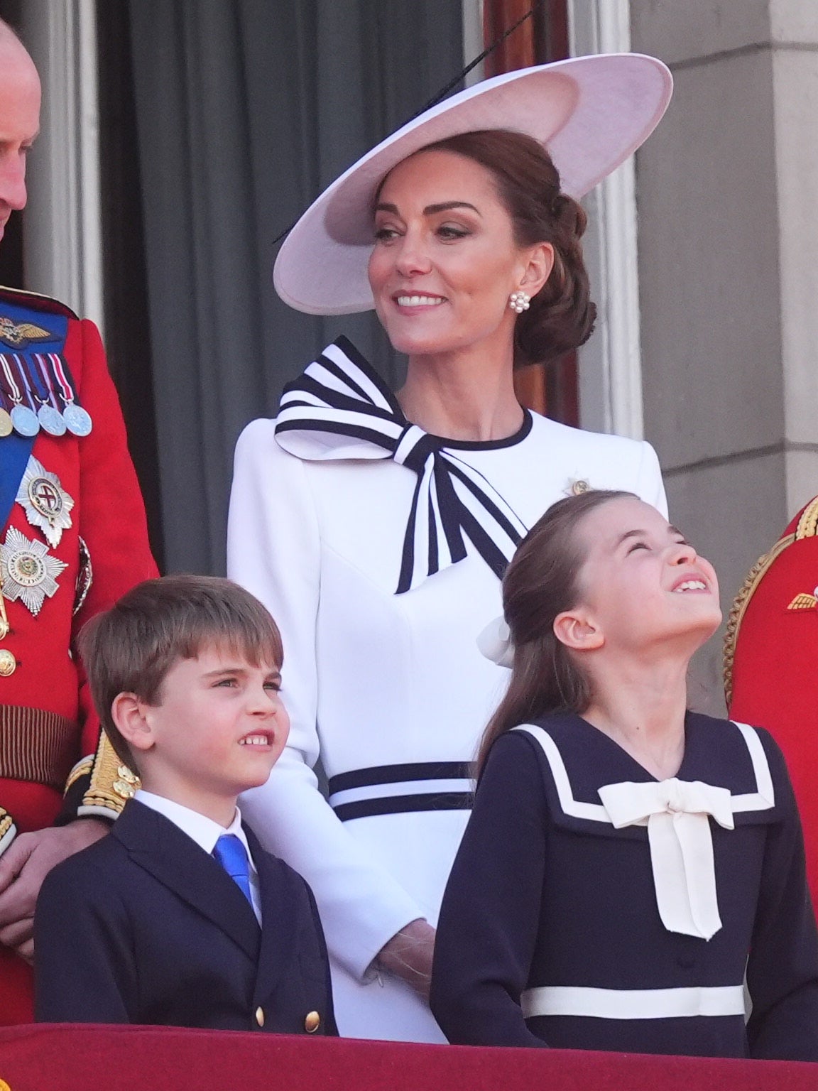 He looks to the skies with his sister Charlotte as the flypast takes place