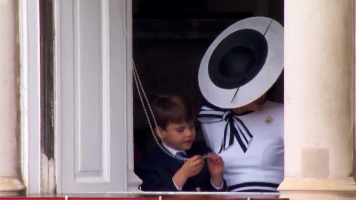Prince Louis plays with Buckingham Palace curtains during Trooping the Colour parade
