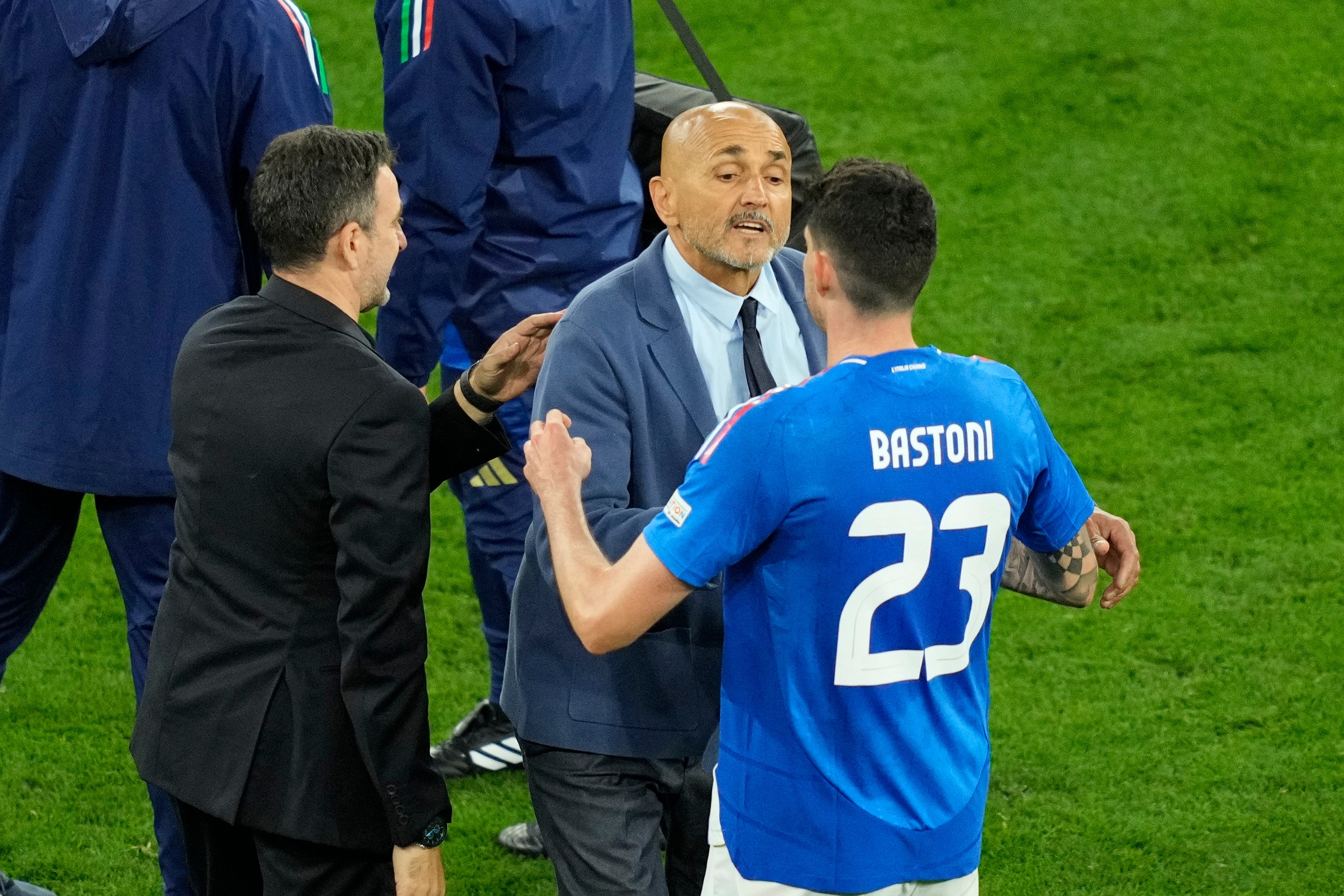 Italy's head coach Spalletti shakes hands with Bastoni