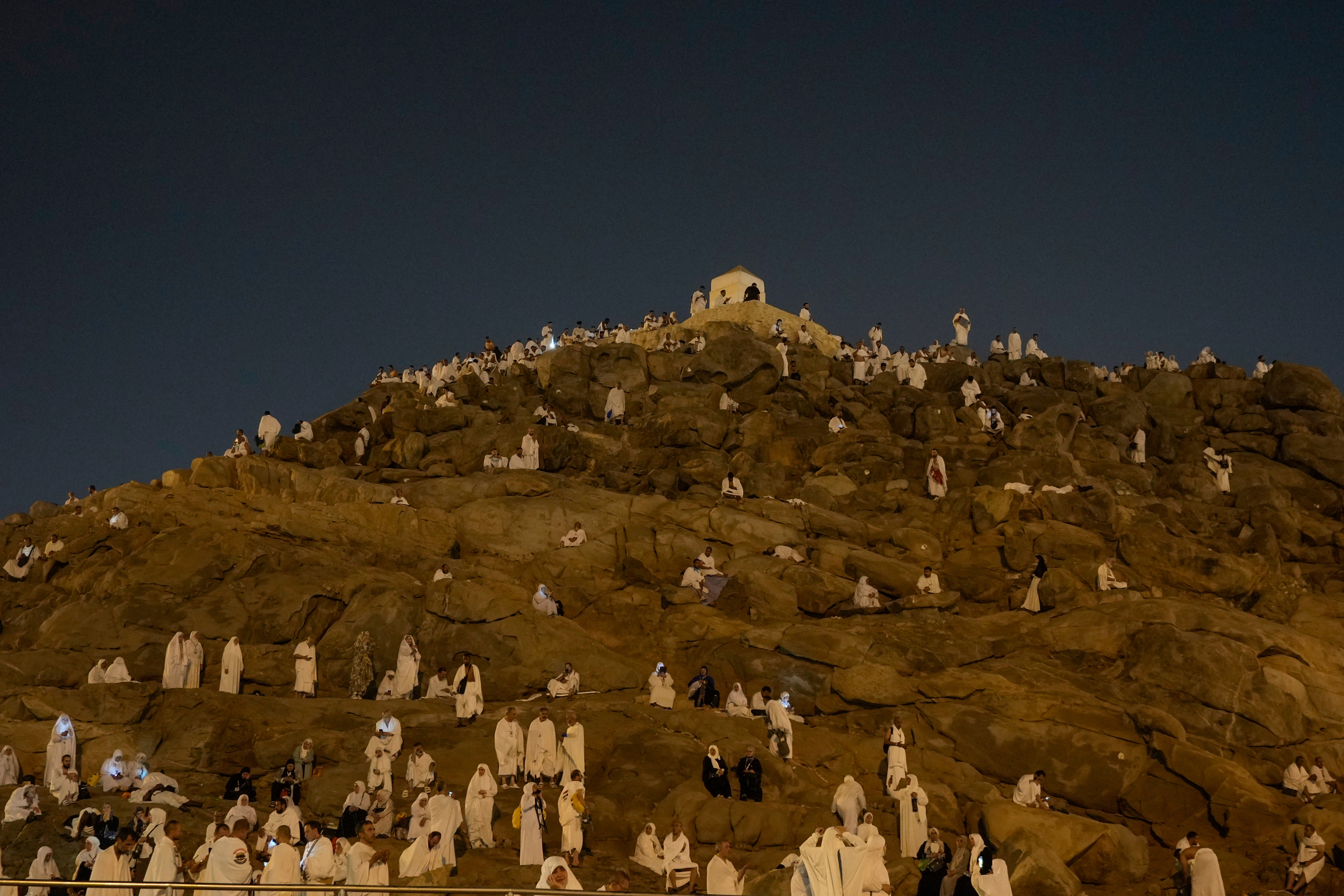 Muslim pilgrims gather at top of the rocky hill known as the Mountain of Mercy, on the Plain of Arafat, during the annual Hajj pilgrimage, near the holy city of Mecca, Saudi Arabia, Saturday, 15 June 2024