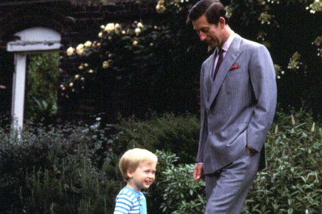 Photo from 1984 of William playing football in the garden of Kensington Palace with his father Charles (PA)