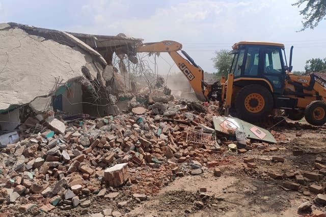 <p>Photos shared by Madhya Pradesh police show the homes being razed</p>