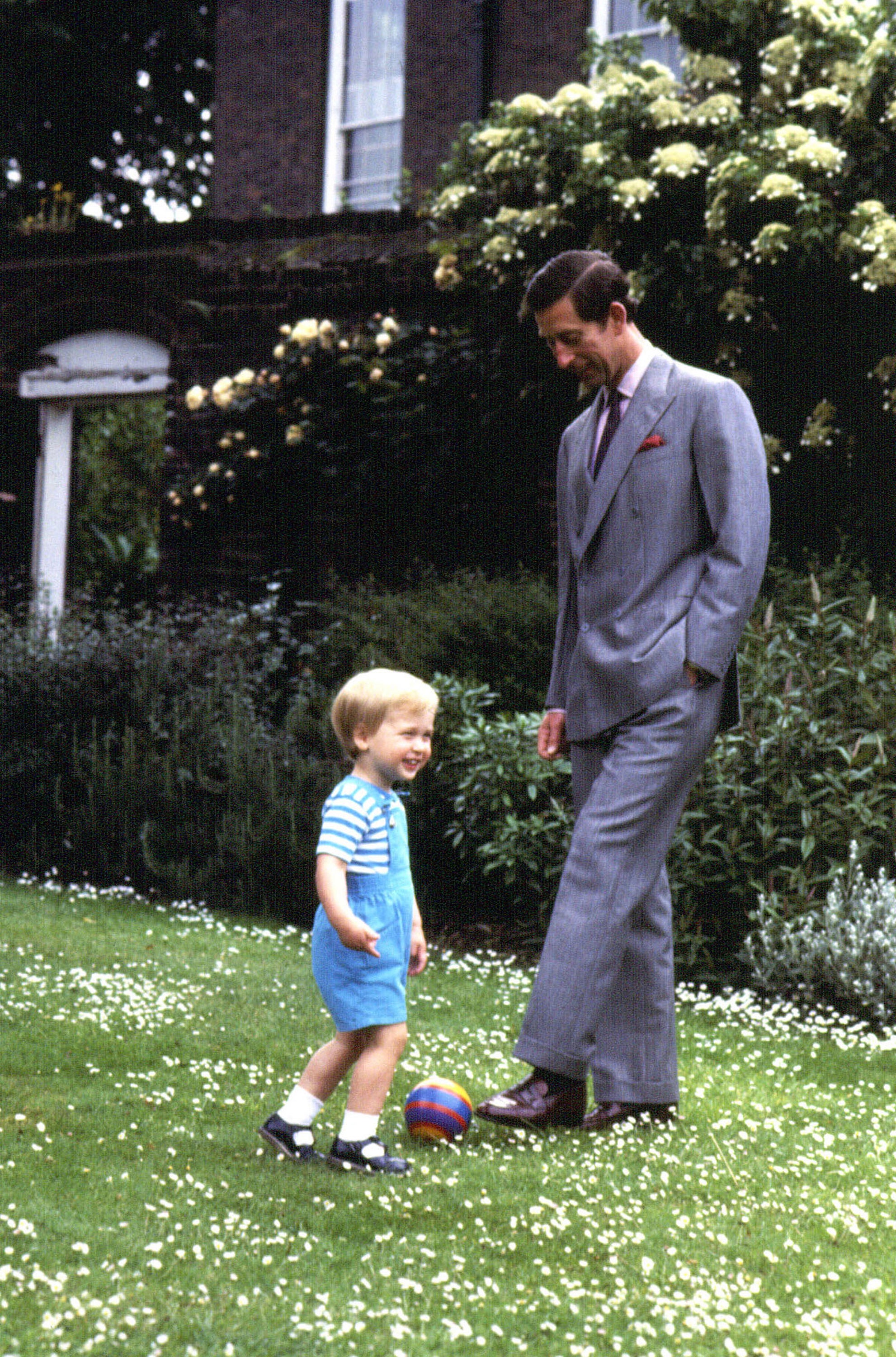 William playing football with his father in 1984