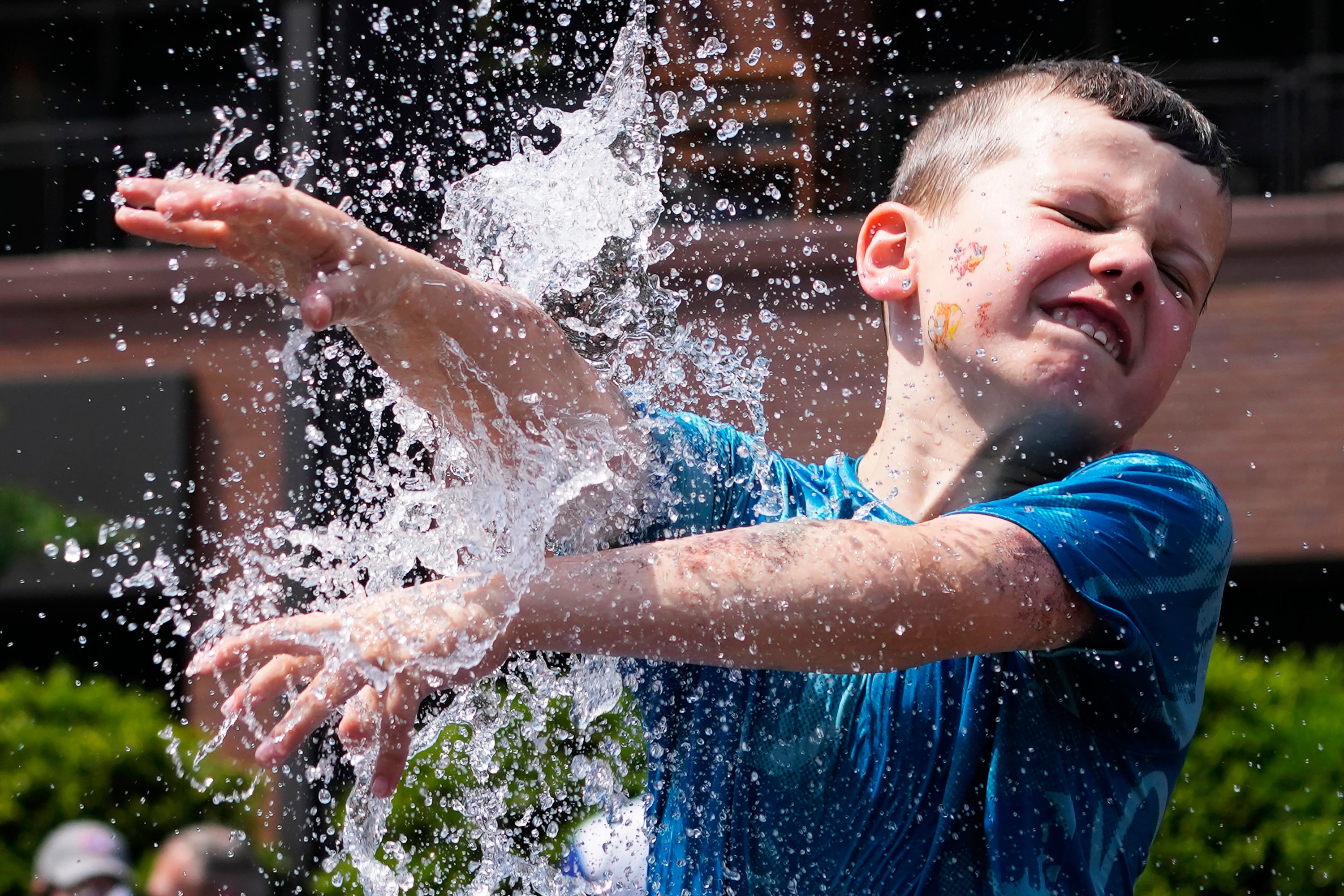 A heat wave is expected to hit much of the US this week from the Midwest to the Northeast. Pictured: a boy cools off at a fountain during hot weather in Chicago on June 16