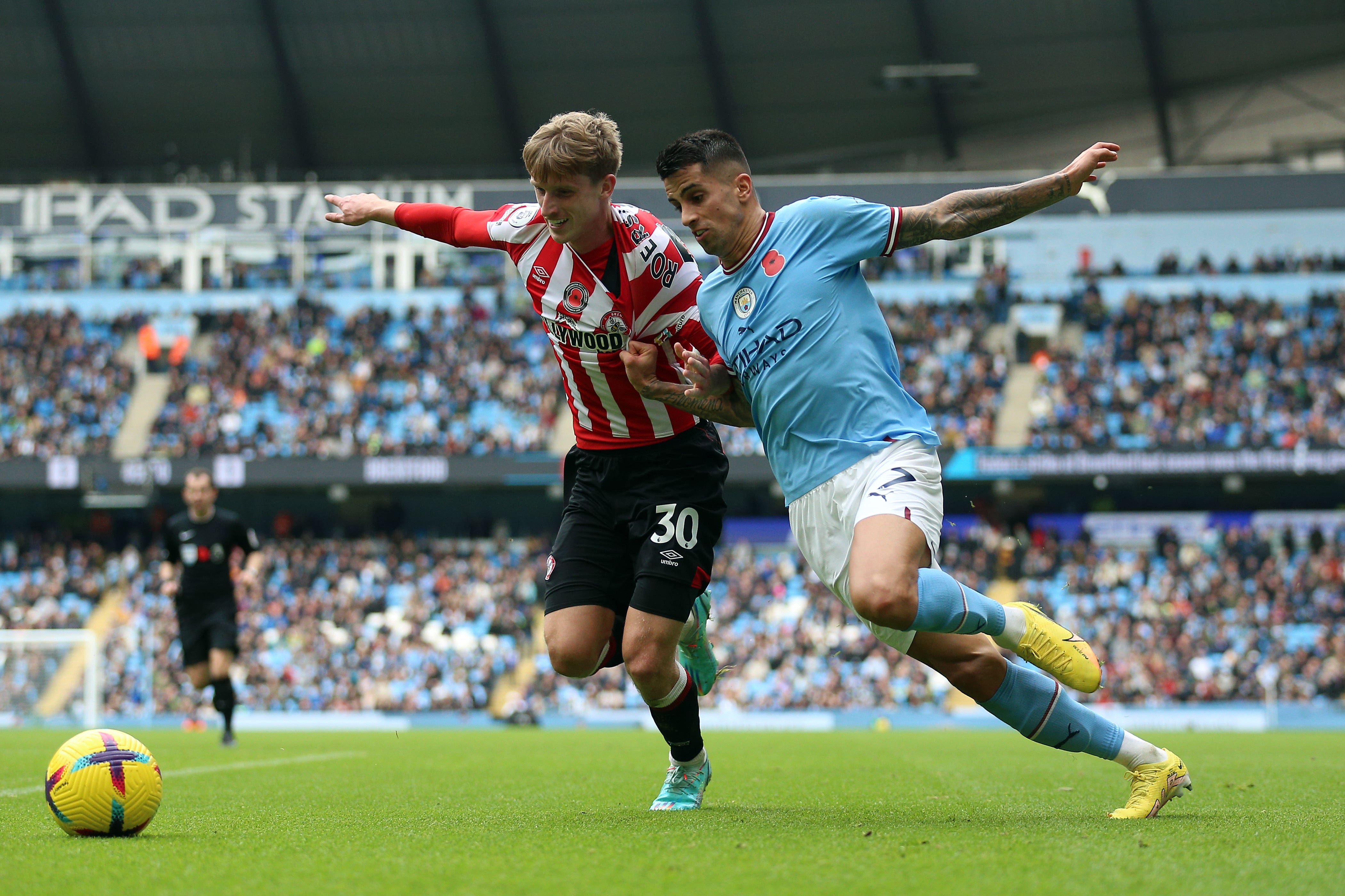 Brentford’s Mads Roerslev and Manchester City’s Joao Cancelo (right) (PA)