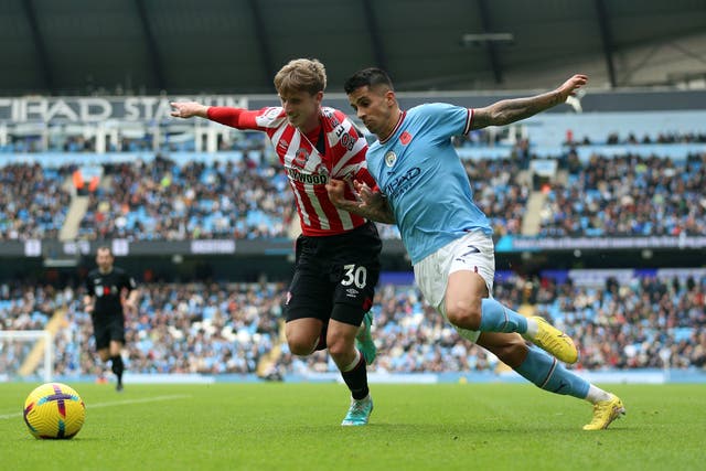 Brentford’s Mads Roerslev and Manchester City’s Joao Cancelo (right) (PA)