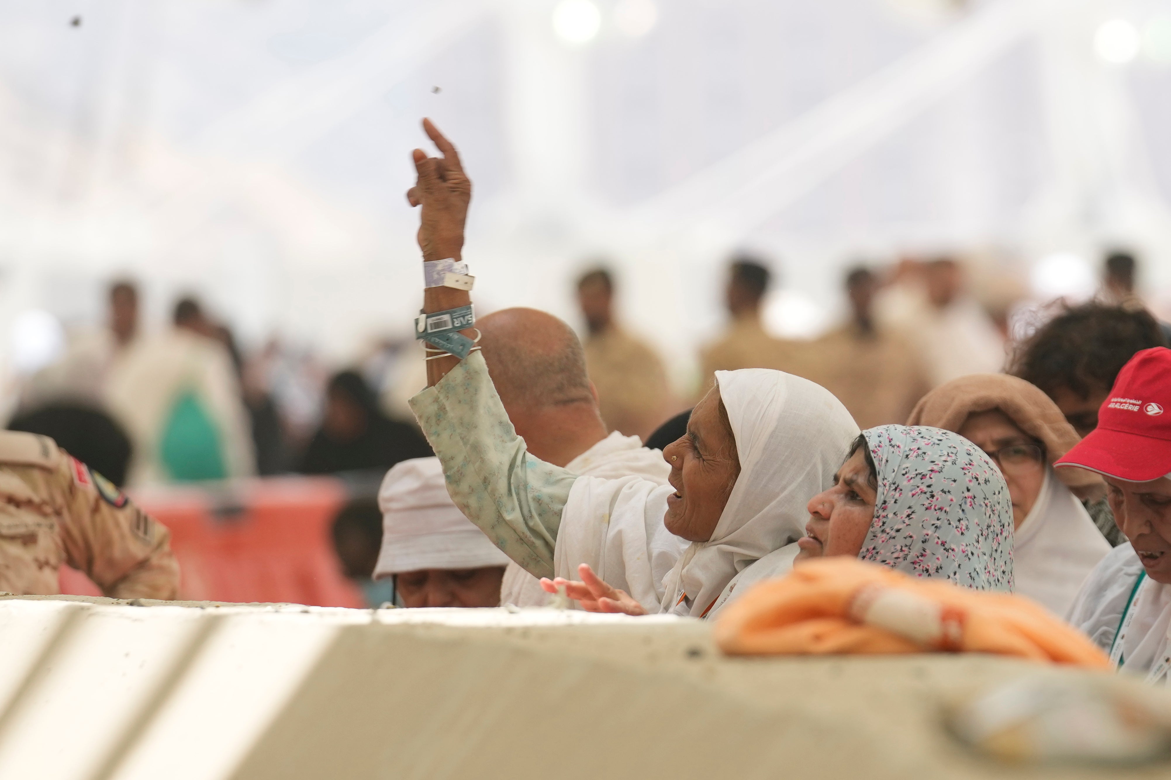 Muslim pilgrims cast stones at pillars in the symbolic stoning of the devil, the last rite of the annual hajj