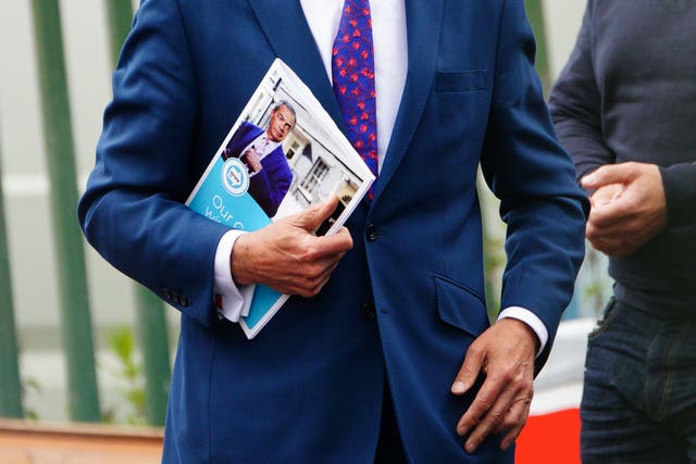 Reform UK leader Nigel Farage holding his party’s ‘contract’ with voters (Ben Birchall/PA)