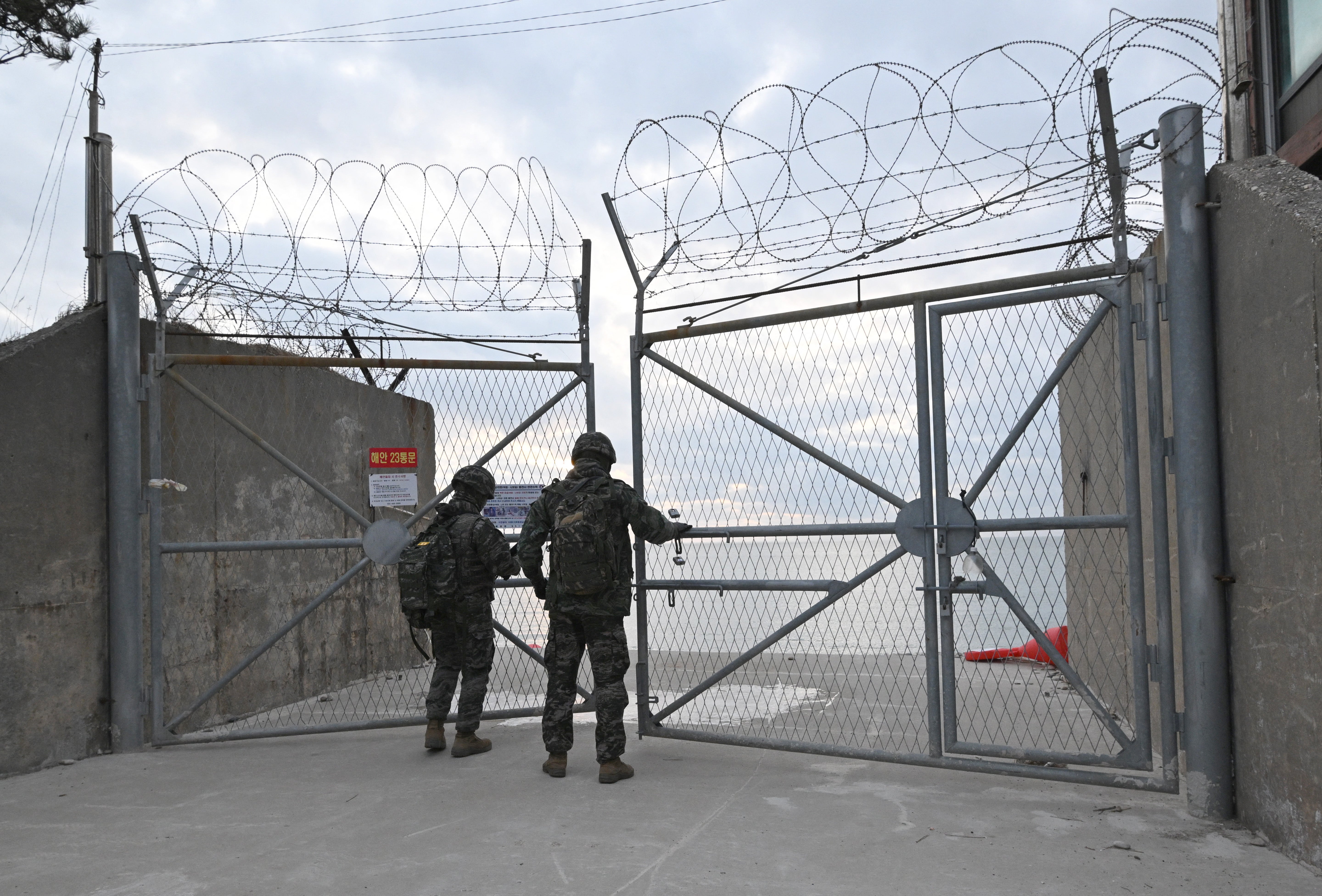 South Korean marines lock the entrance to a beach on Yeonpyeong island, near the 'northern limit line' sea boundary with North Korea