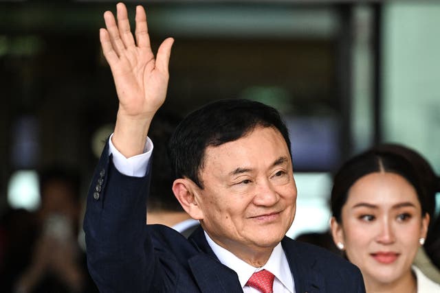 <p>Thaksin Shinawatra greets supporters next to his daughter Paetongtarn Shinawatra after landing at Bangkok's Don Mueang airport on 22 August 2023</p>