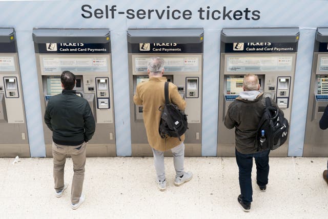 <p>Passengers using a ticket machine at London Waterloo station</p>