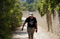 A man walks in the village of Rovinia on the island of Corfu