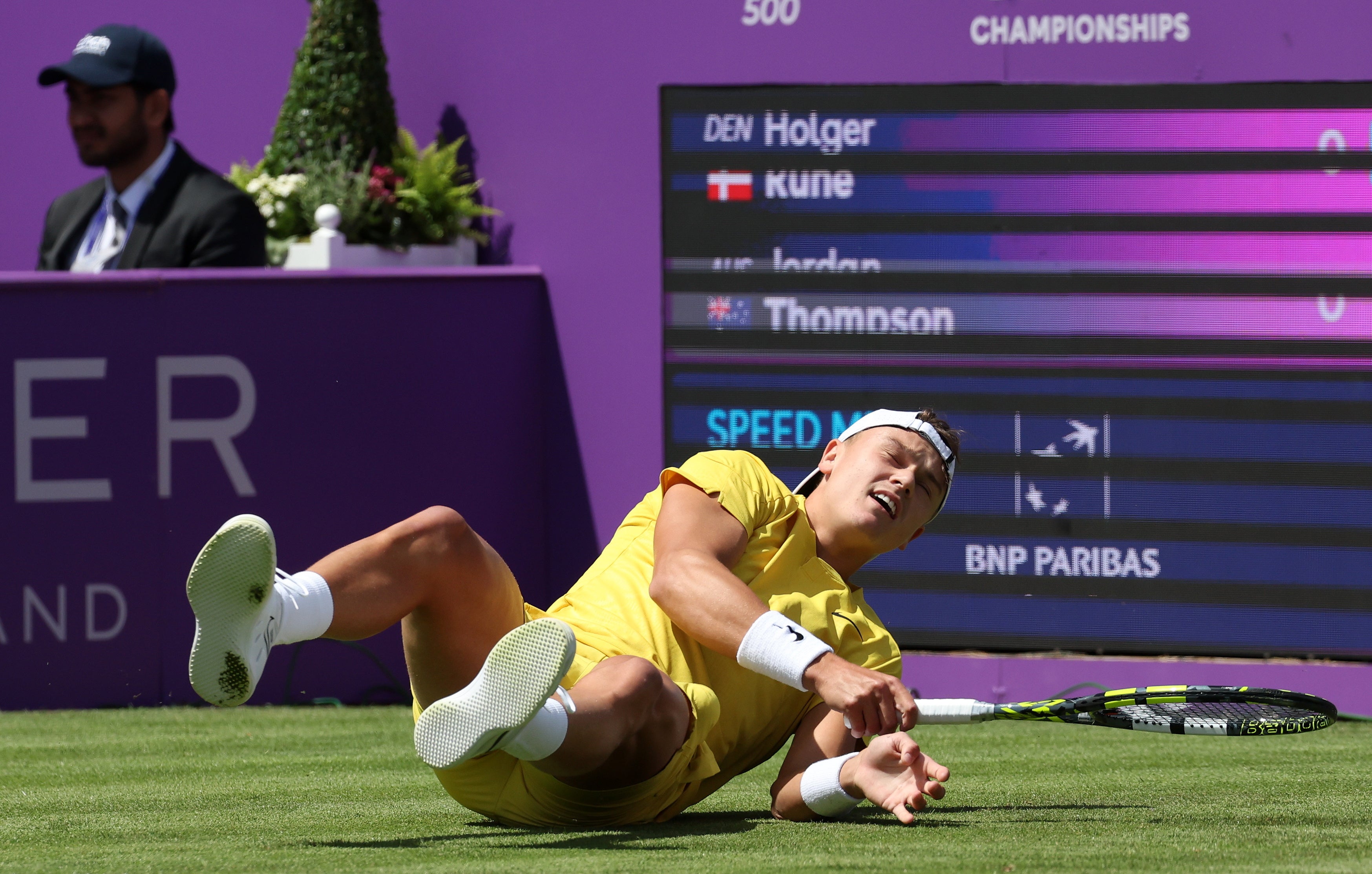 Holger Rune slips to the ground during his first-round defeat