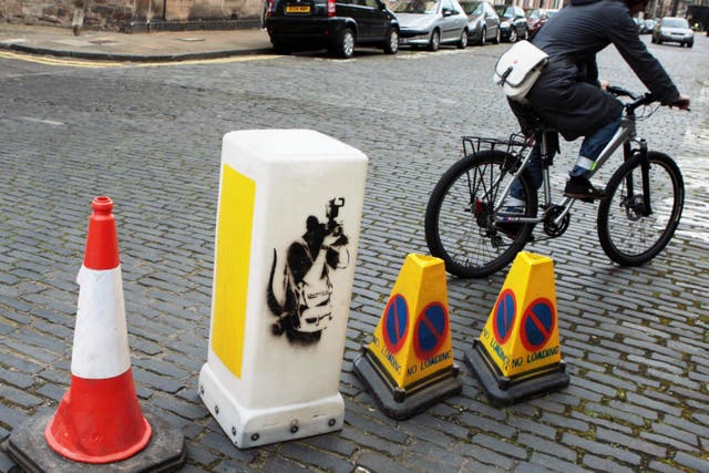 A bollard featuring one of Banksy’s rats is going under the hammer in an auction of street art (David Cheskin/PA)